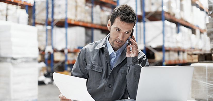 Man in Order Fulfillment Warehouse Working an Order on Phone